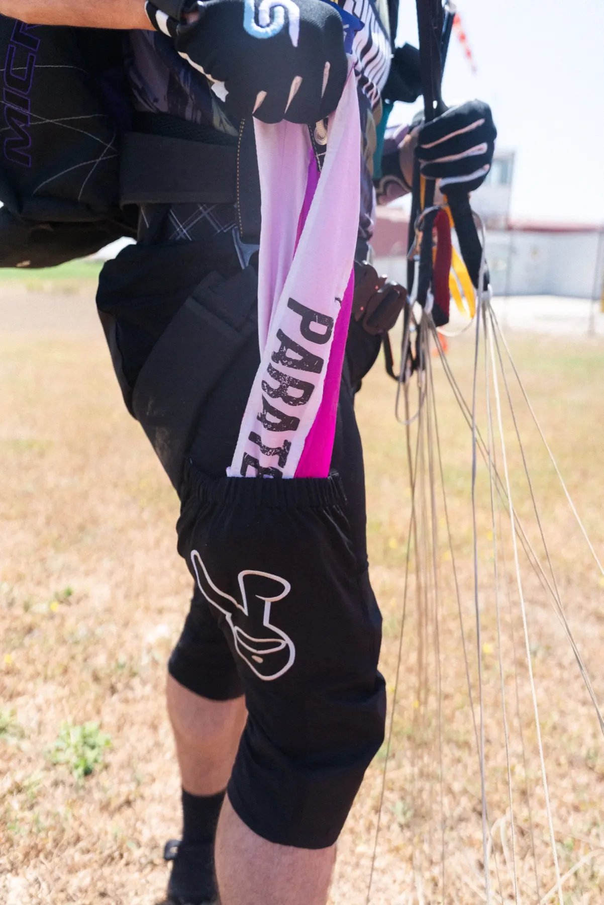 Skydiver using a leg pocket while wearing Skyrabbit shorts